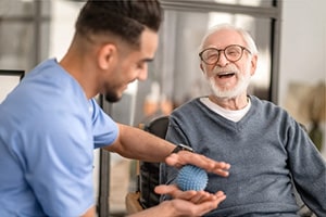 PACS-300x200-rehab1 A rehab therapist helping an elderly gentleman in the rehab gym