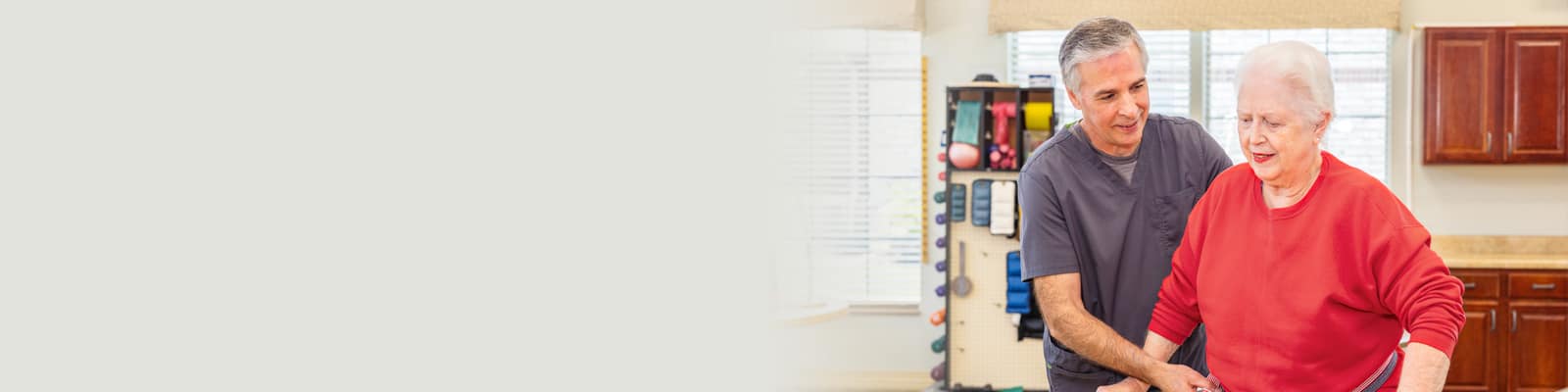 A physical therapist working with an elderly woman