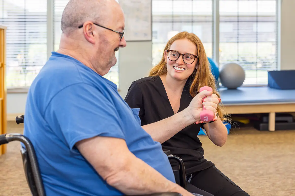A physical therapist working with a man at Villages of St Peters
