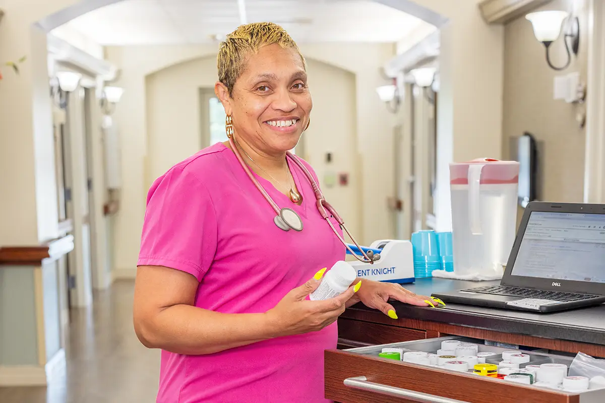 A nurse smiling at Villages of St Peters