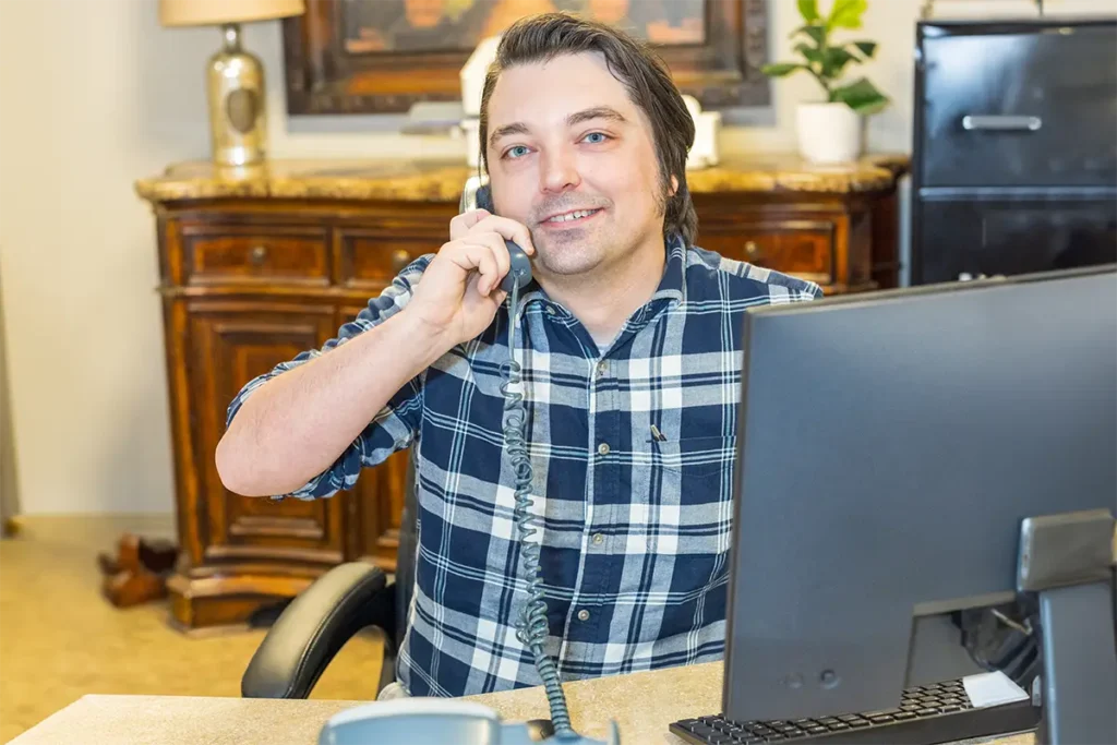 An employee of Villages of St Peters on the phone