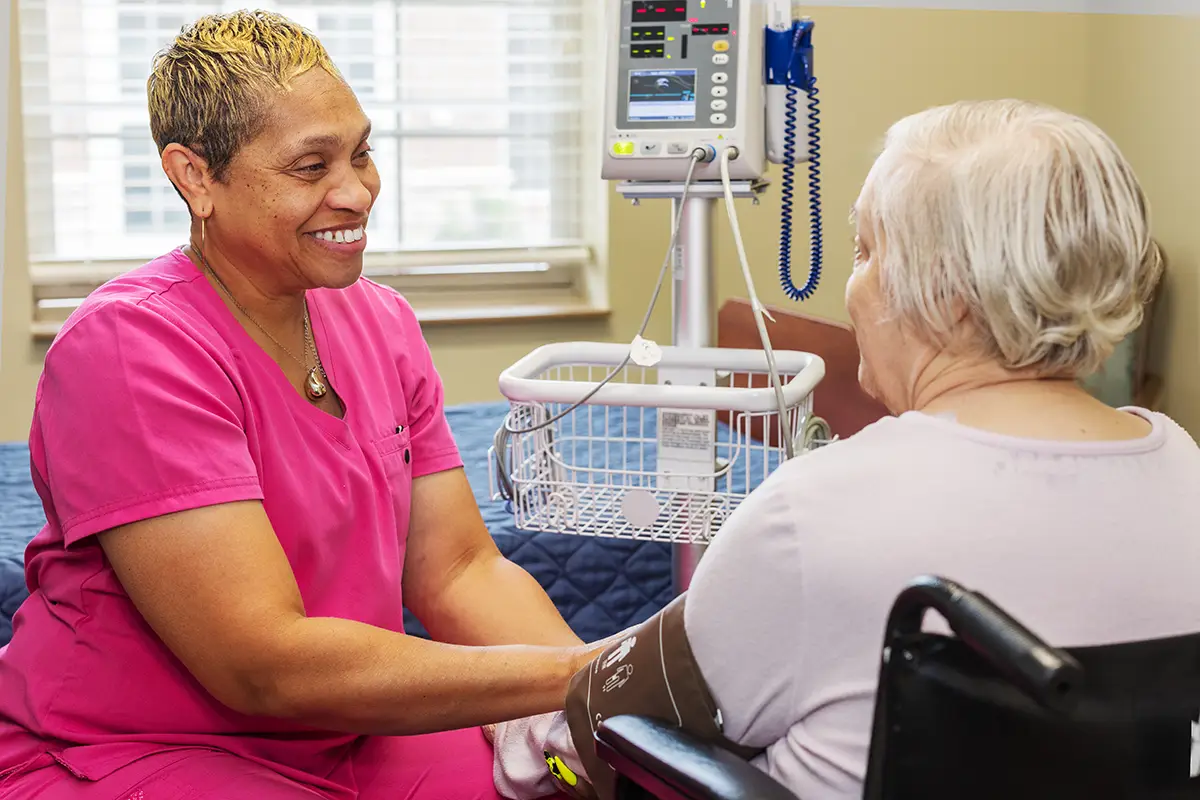Nurse working with a woman resident at Villages of St Peters