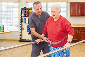 A woman doing physical therapy with a therapist at Villages of St Peters