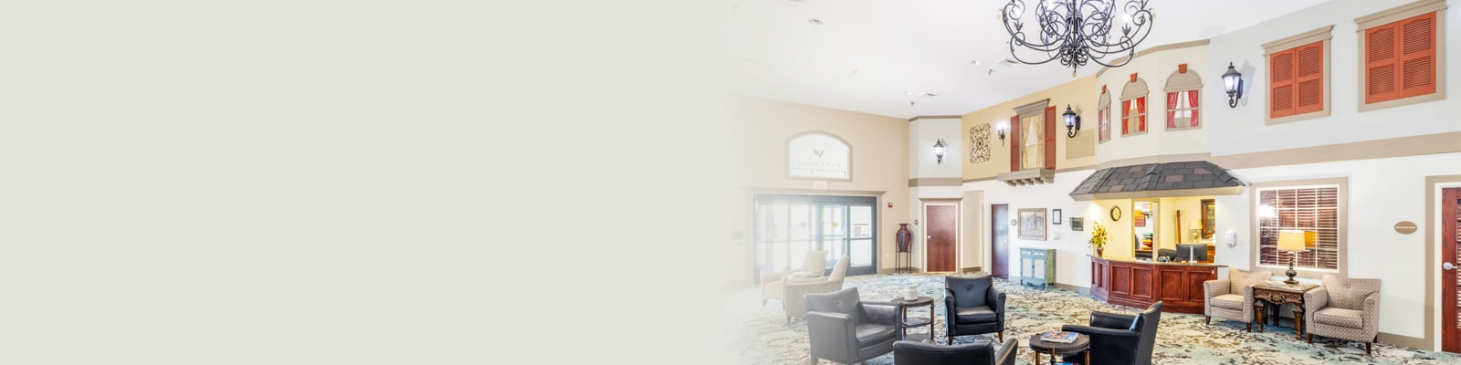 A large common room with couches and a chandelier