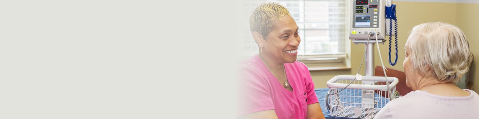 A nurse smiling at a resident at Villages of St Peters
