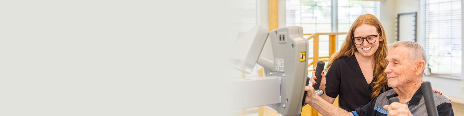 A physical therapist helping a man do therapy at Villages of St Peters