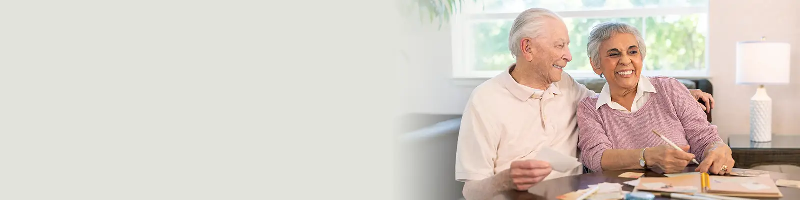 An elderly couple laughing together